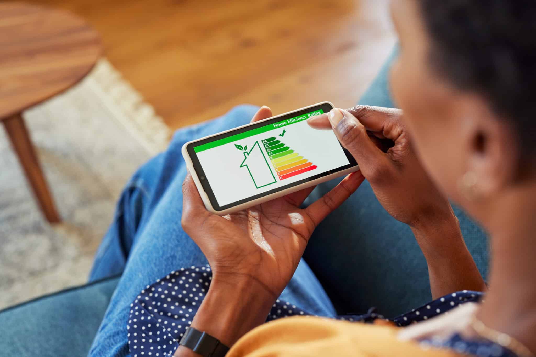 A woman checks her home efficiency report after upgrading to a heat pump system.