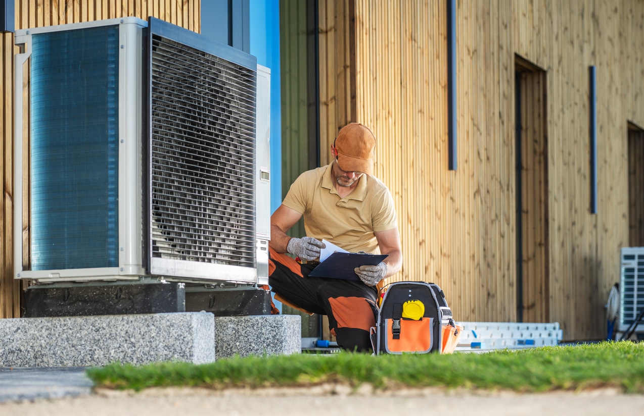 A certified heat pump contractor installing a brand-new heat pump to save the client money.